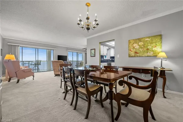a view of a dining room with furniture and chandelier