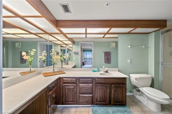 a bathroom with a sink vanity and toilet