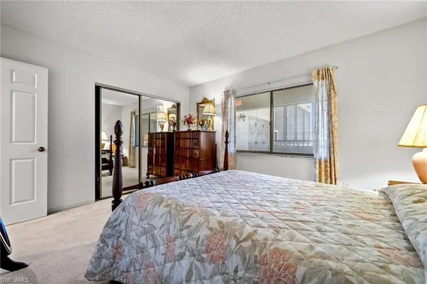 a bed room with a bed and a large mirror