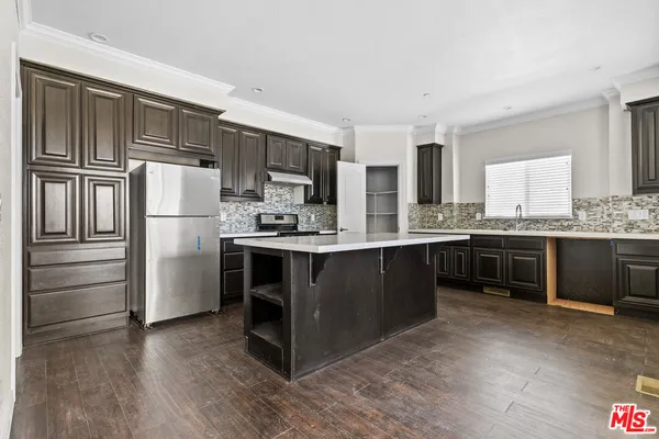a kitchen with granite countertop stainless steel appliances and cabinets