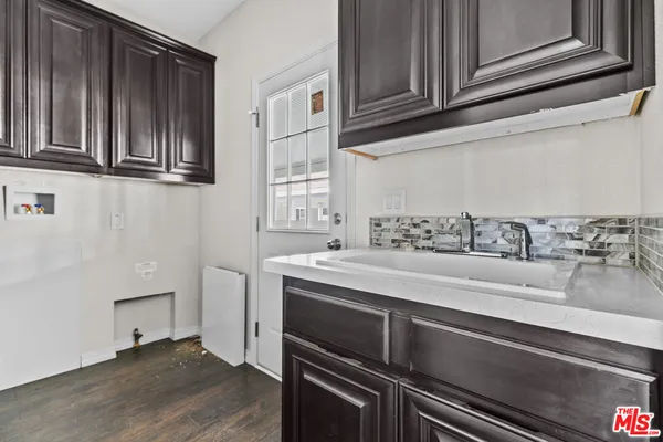 an empty room with wooden floor and closet