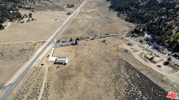 a view of a house with yard and lake view