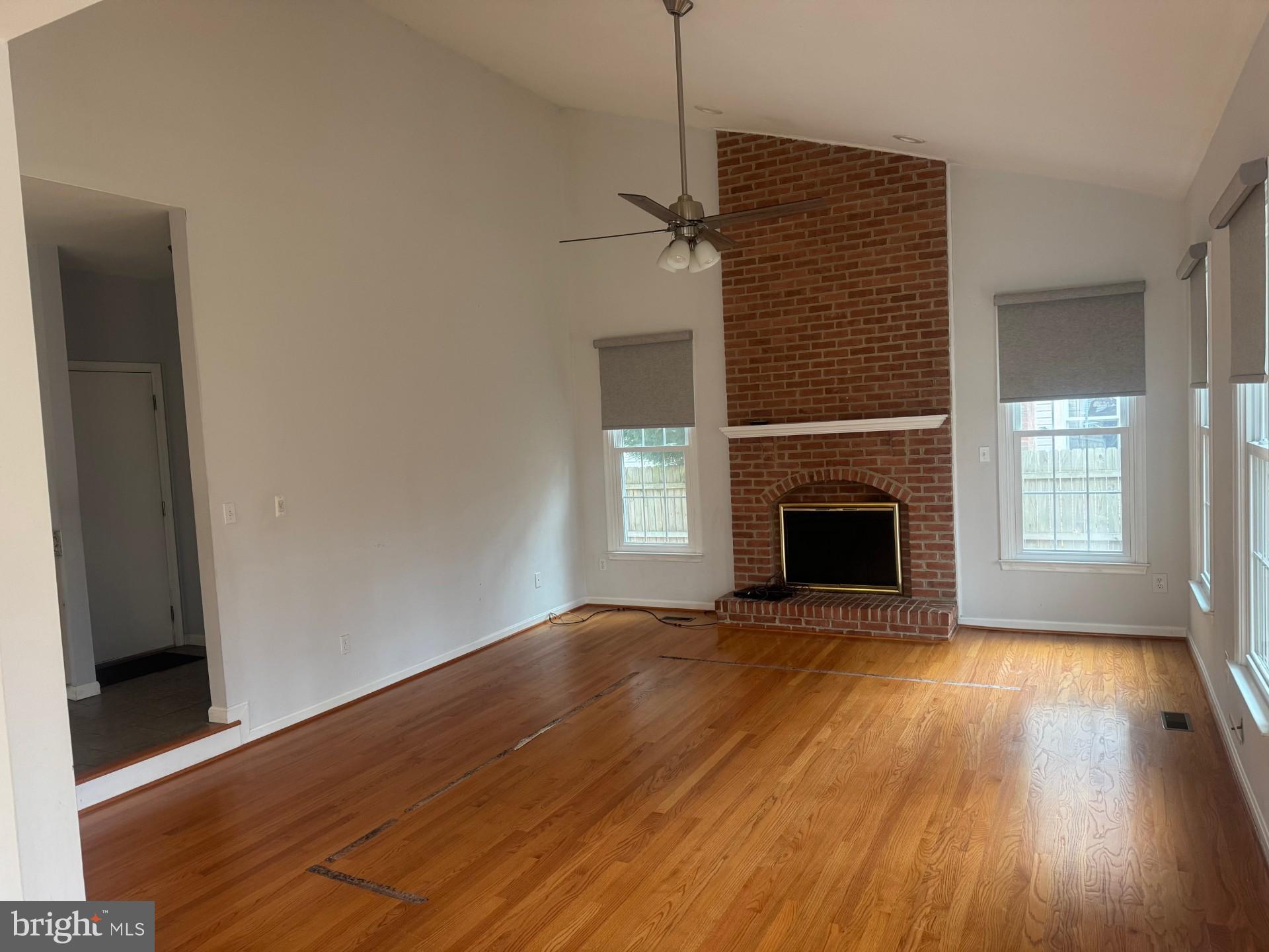 8143 Ridge Creek Way Springfield, VA 22153 - Photo 11 of 42 a view of empty room with wooden floor and fireplace