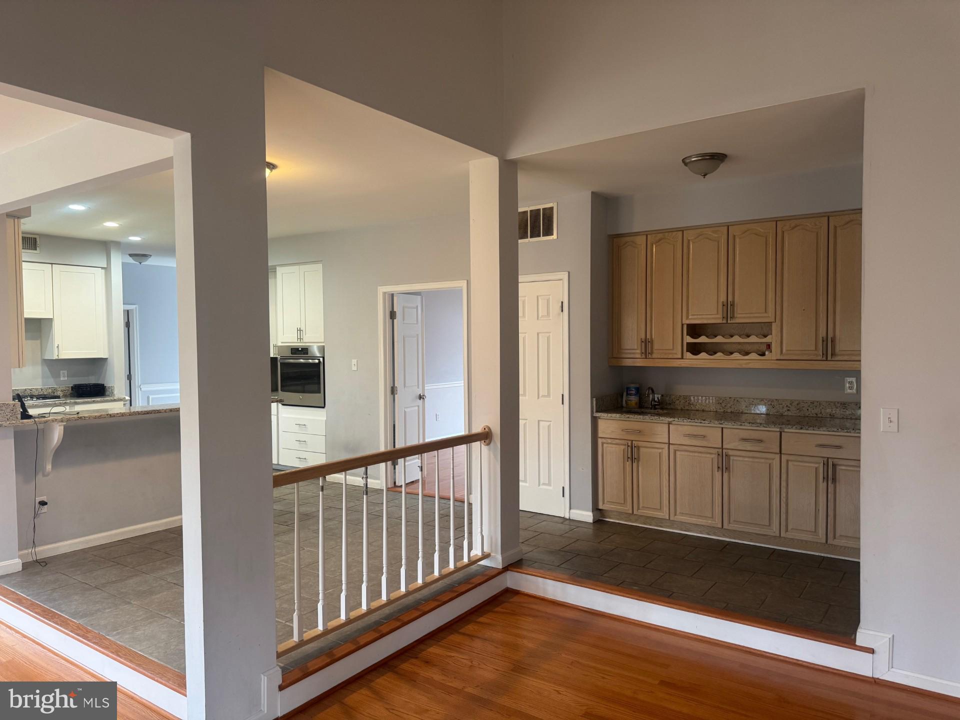 8143 Ridge Creek Way Springfield, VA 22153 - Photo 12 of 42 a kitchen with granite countertop white cabinets and appliances