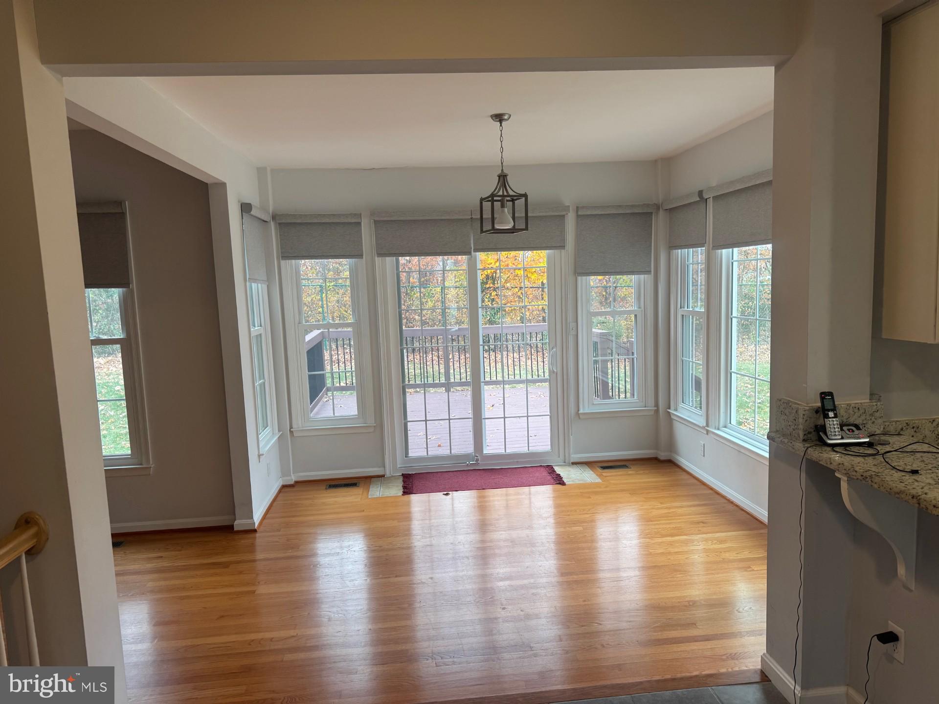 8143 Ridge Creek Way Springfield, VA 22153 - Photo 14 of 42 a view of an empty room with window and wooden floor