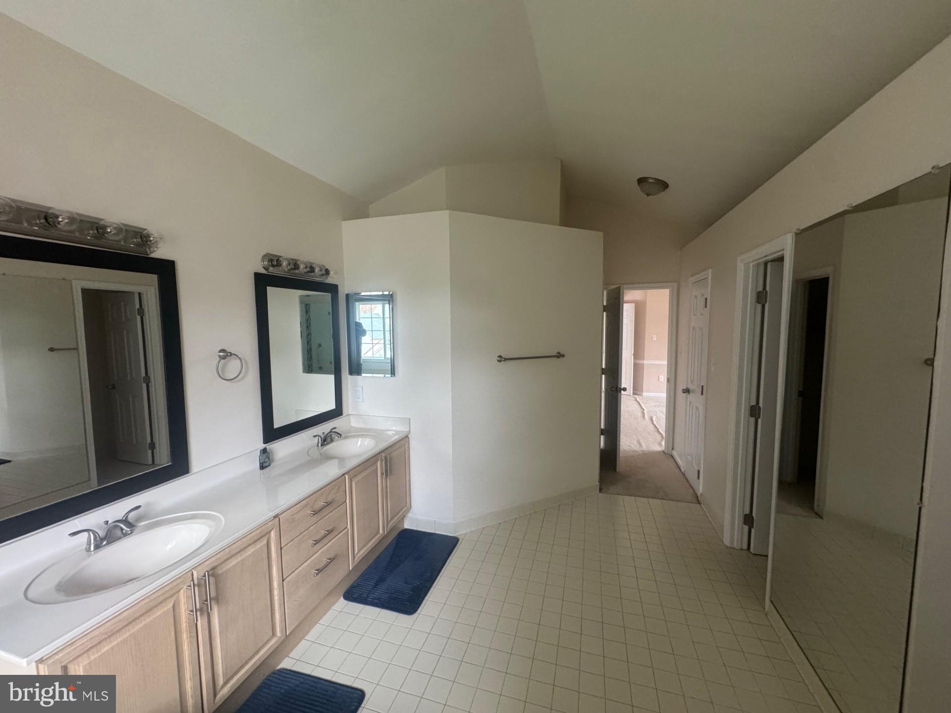 8143 Ridge Creek Way Springfield, VA 22153 - Photo 20 of 42 a bathroom with a double vanity sink mirror and bathtub