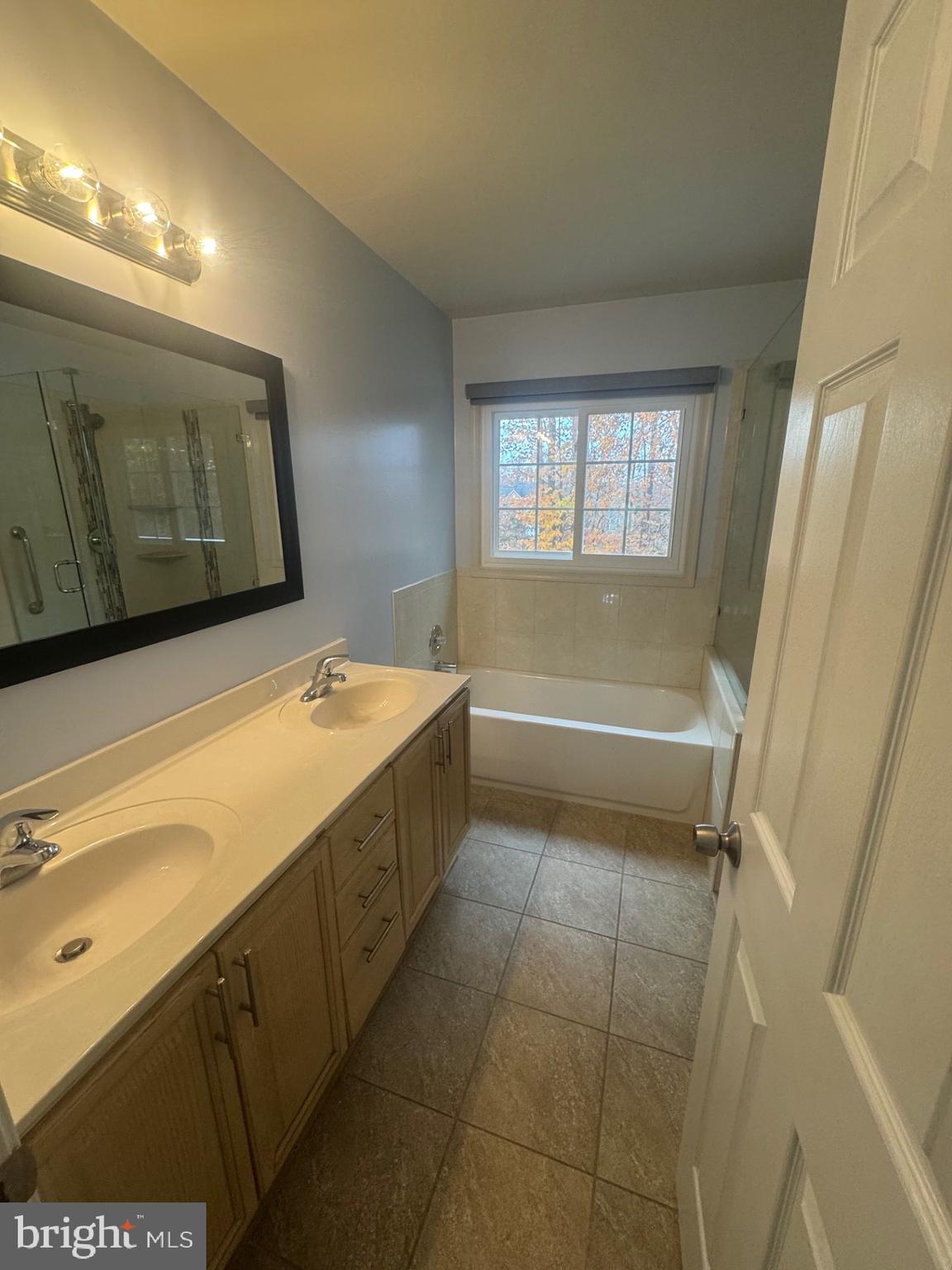 8143 Ridge Creek Way Springfield, VA 22153 - Photo 26 of 42 a bathroom with a bathtub and a shower