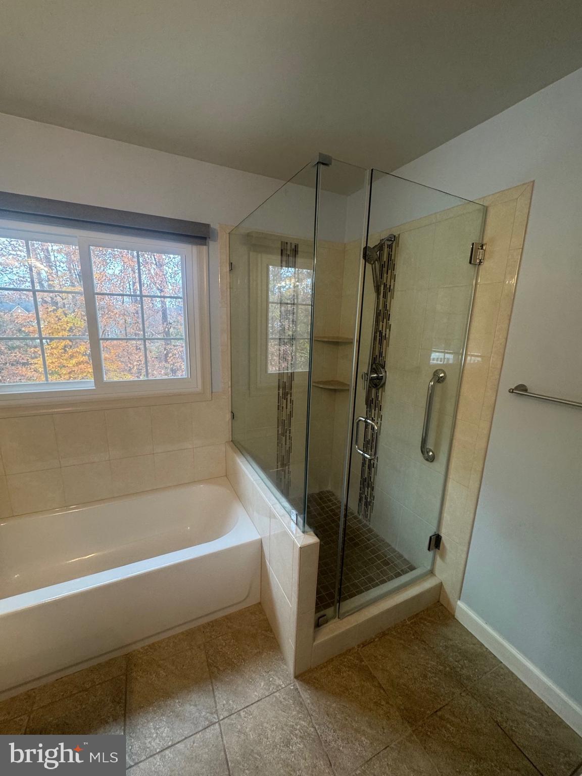 8143 Ridge Creek Way Springfield, VA 22153 - Photo 27 of 42 a spacious bathroom with a bath tub and shower