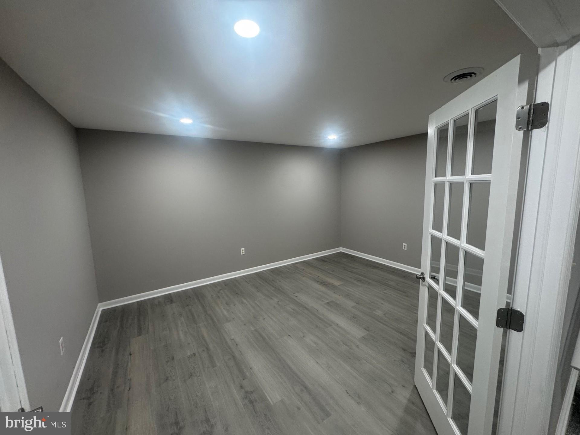 8143 Ridge Creek Way Springfield, VA 22153 - Photo 31 of 42 an empty room with wooden floor and entrance