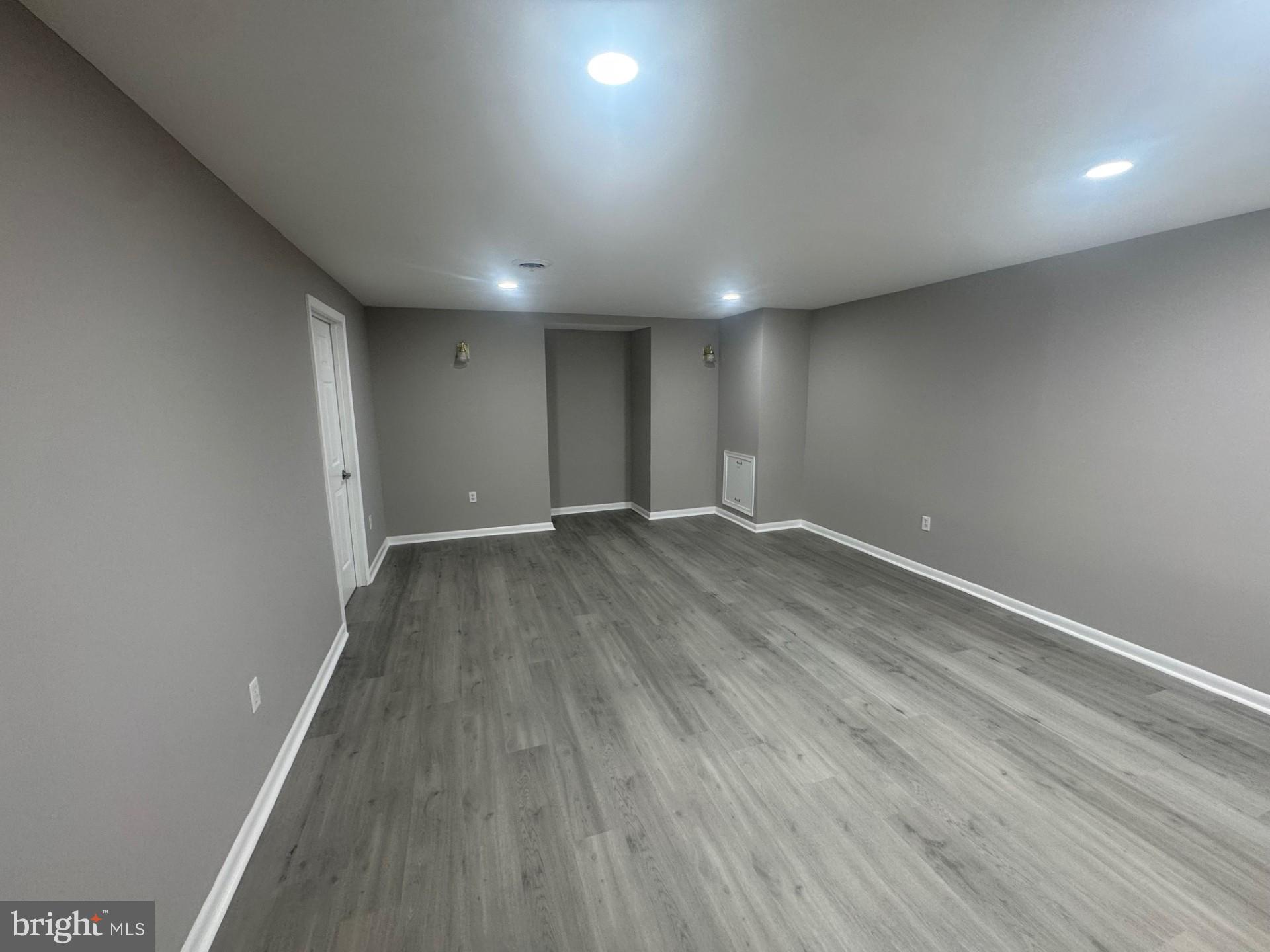 8143 Ridge Creek Way Springfield, VA 22153 - Photo 33 of 42 an empty room with wooden floor and windows