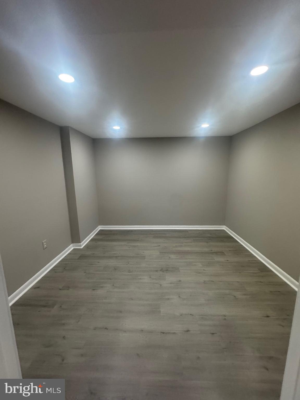 8143 Ridge Creek Way Springfield, VA 22153 - Photo 34 of 42 an empty room with wooden floor and windows