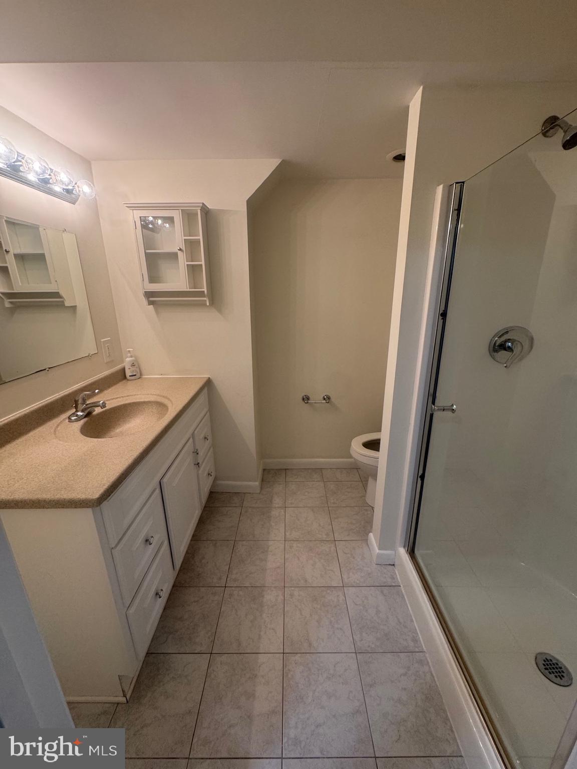 8143 Ridge Creek Way Springfield, VA 22153 - Photo 37 of 42 a bathroom with a sink a toilet and a mirror