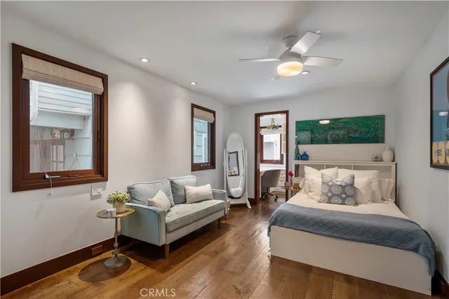 a bedroom with two beds and a large window