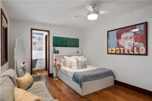 a living room with furniture a large window and potted plants