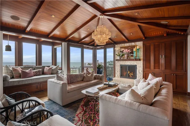 a living room with furniture a fireplace and a table