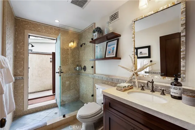 a view of a patio with couches and table and chairs and potted plants