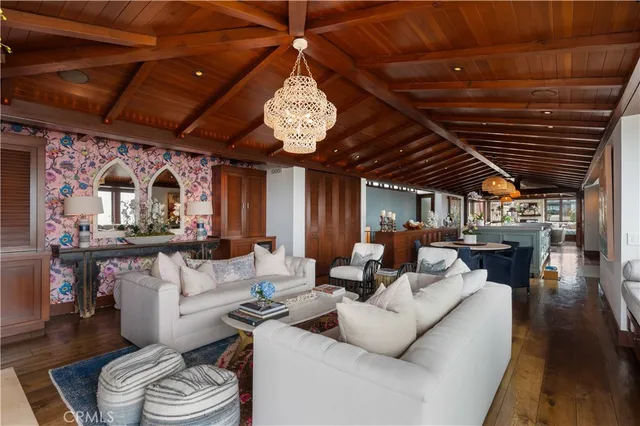 a living room with furniture a fireplace and a large window