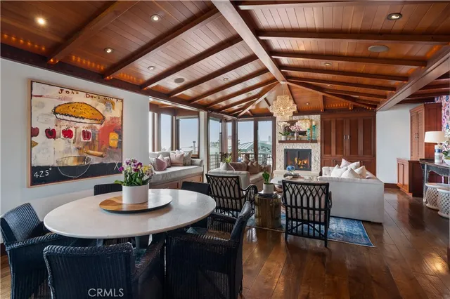a living room with fireplace furniture and a large window