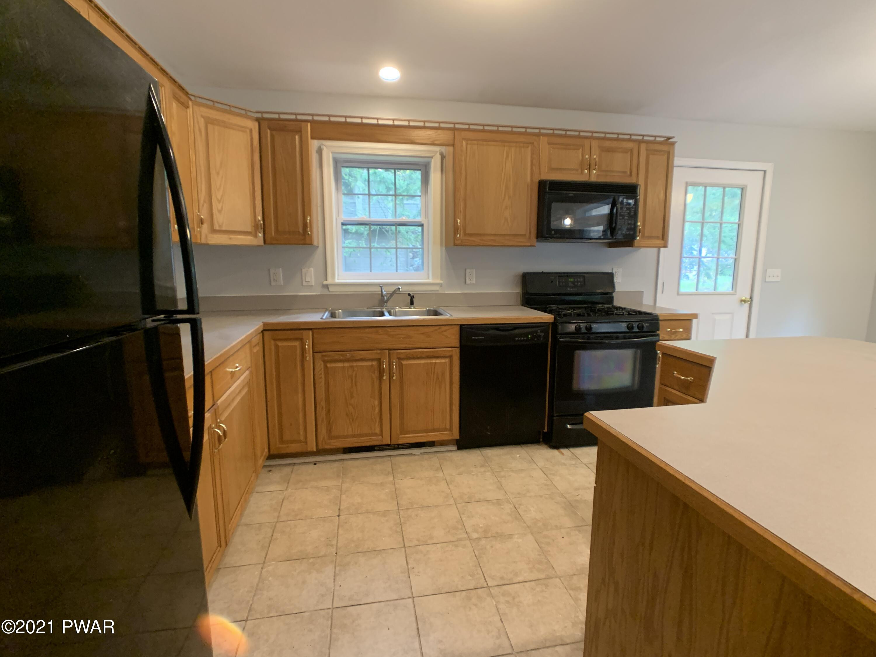267 North Northgate Road Lake Ariel, PA 18436 - Photo 8 of 29 a kitchen with stainless steel appliances granite countertop a sink stove and refrigerator