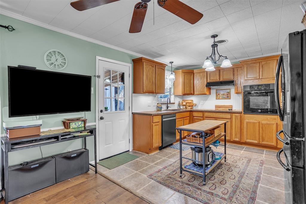 709 Hurstview Drive Hurst, TX 76053 - Photo 9 of 28 a kitchen with a refrigerator cabinets and wooden floor