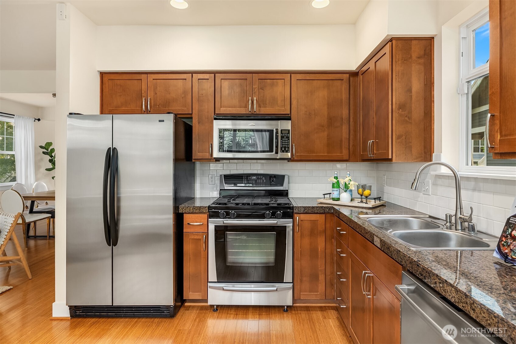 1748 25th Walk Northeast Issaquah, WA 98029 - Photo 14 of 40 a kitchen with stainless steel appliances granite countertop a stove a sink and a refrigerator