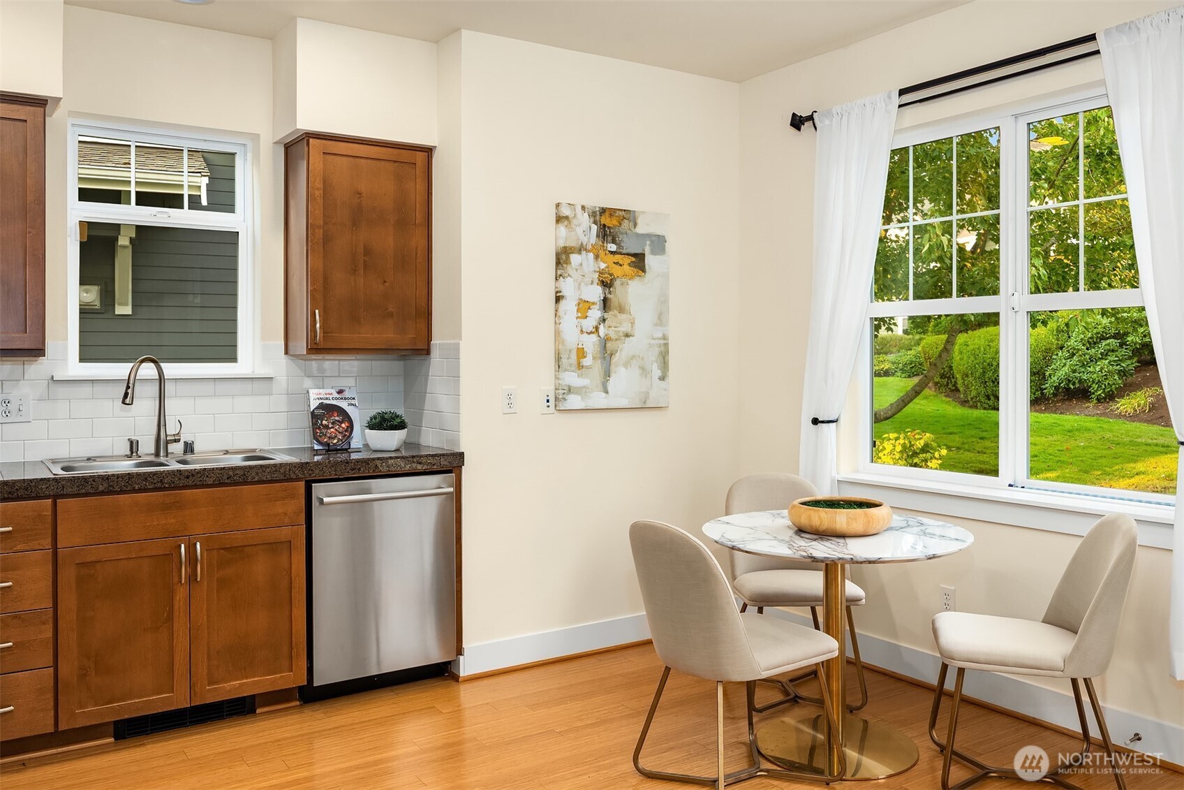 1748 25th Walk Northeast Issaquah, WA 98029 - Photo 15 of 40 a kitchen with stainless steel appliances granite countertop a table chairs and a window