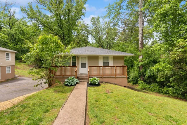 a view of a house with backyard and sitting area