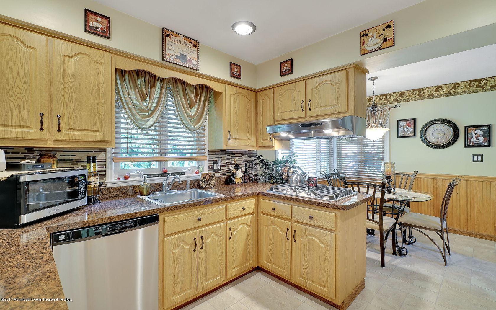 9 Cornwall Road Freehold, NJ 07728 - Photo 13 of 38 a kitchen with stainless steel appliances granite countertop a sink and cabinets