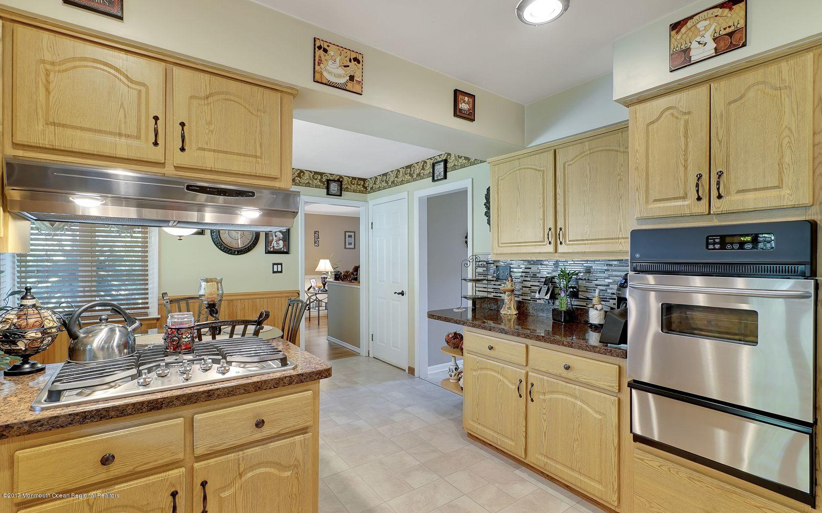 9 Cornwall Road Freehold, NJ 07728 - Photo 14 of 38 a kitchen with cabinets and stainless steel appliances