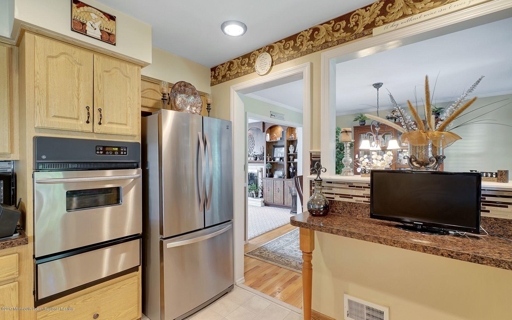 9 Cornwall Road Freehold, NJ 07728 - Photo 15 of 38 a kitchen with stainless steel appliances granite countertop a refrigerator a oven a sink and a refrigerator