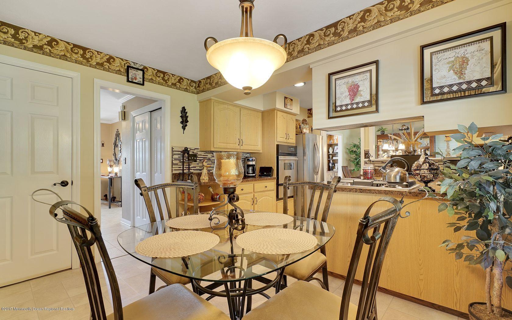 9 Cornwall Road Freehold, NJ 07728 - Photo 19 of 38 a view of a dining room with furniture and a chandelier