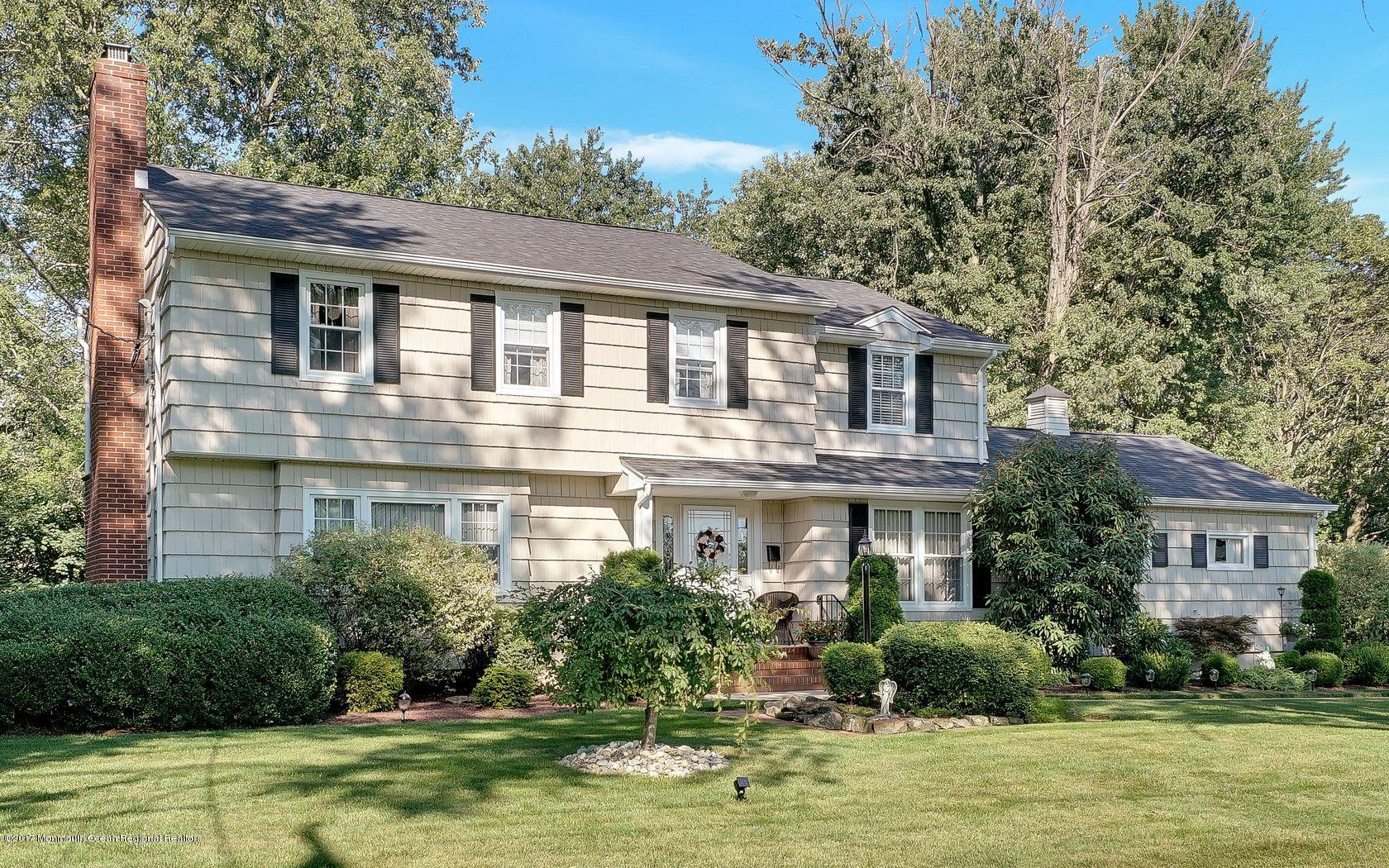 9 Cornwall Road Freehold, NJ 07728 - Photo 2 of 38 a front view of a house with a yard table and chairs
