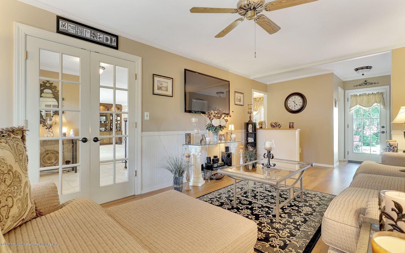 9 Cornwall Road Freehold, NJ 07728 - Photo 22 of 38 a bedroom with a bed and a chandelier