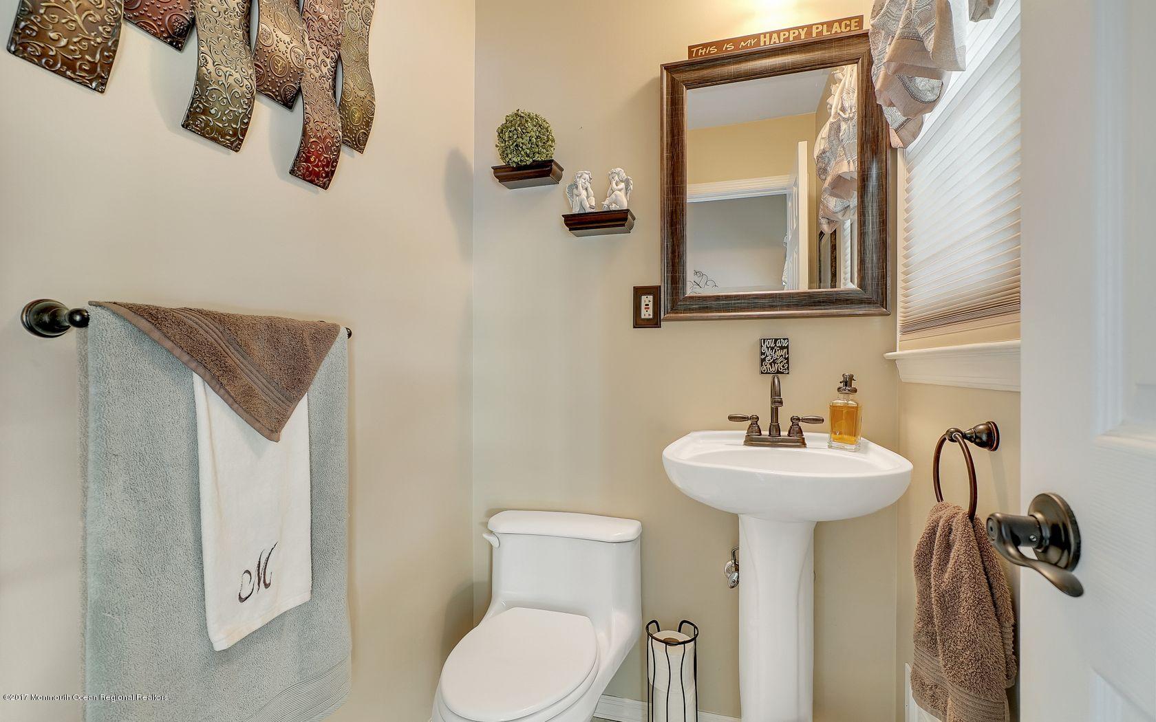 9 Cornwall Road Freehold, NJ 07728 - Photo 23 of 38 a bathroom with a sink mirror and toilet