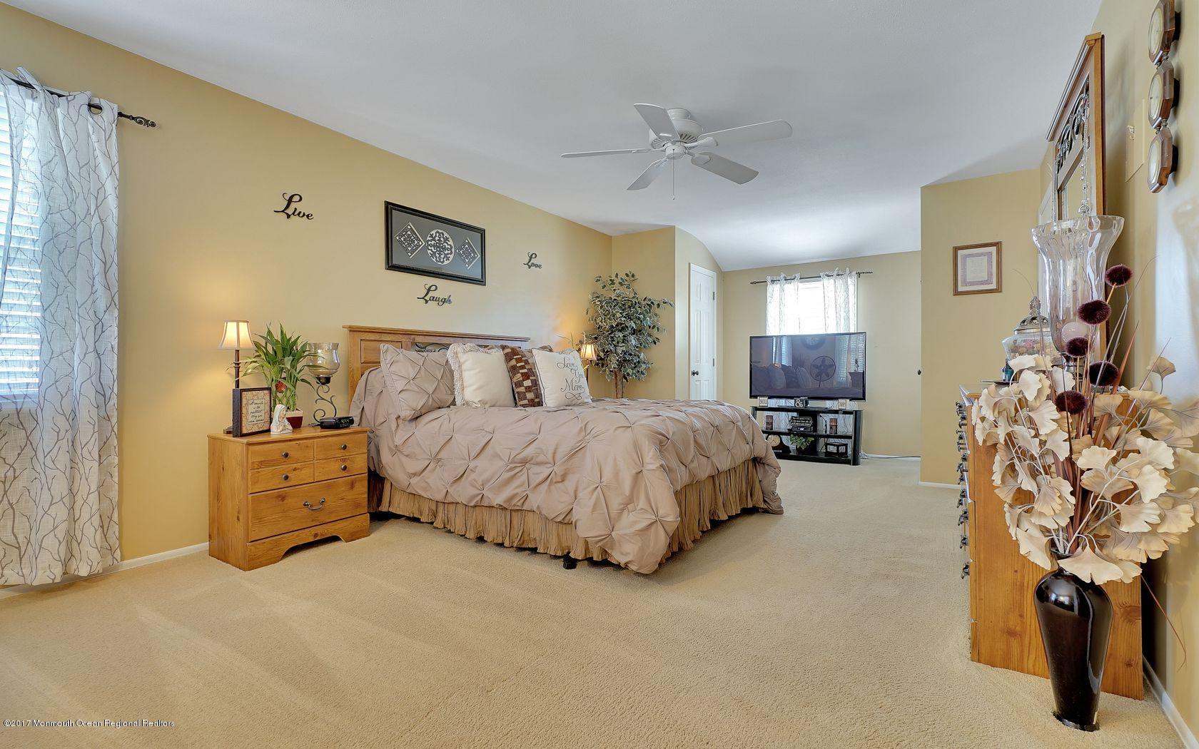 9 Cornwall Road Freehold, NJ 07728 - Photo 25 of 38 a spacious bedroom with a bed and dresser with mirror