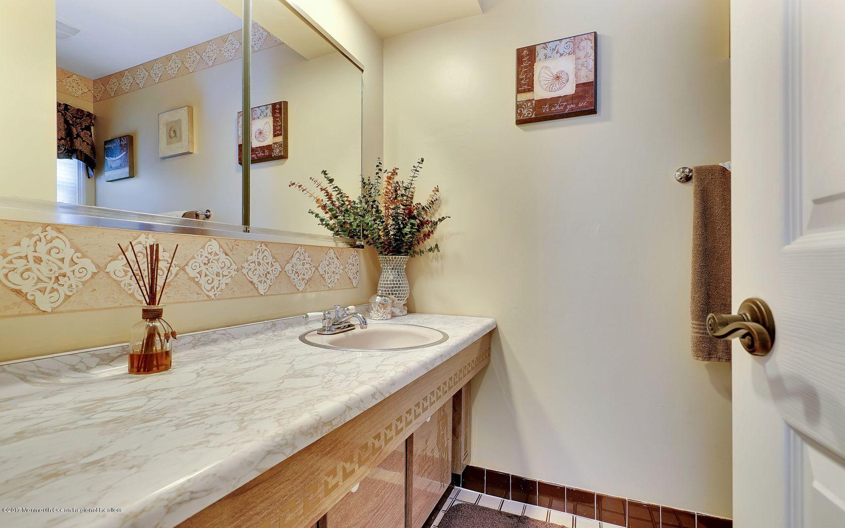 9 Cornwall Road Freehold, NJ 07728 - Photo 27 of 38 a bathroom with a granite countertop sink and a mirror