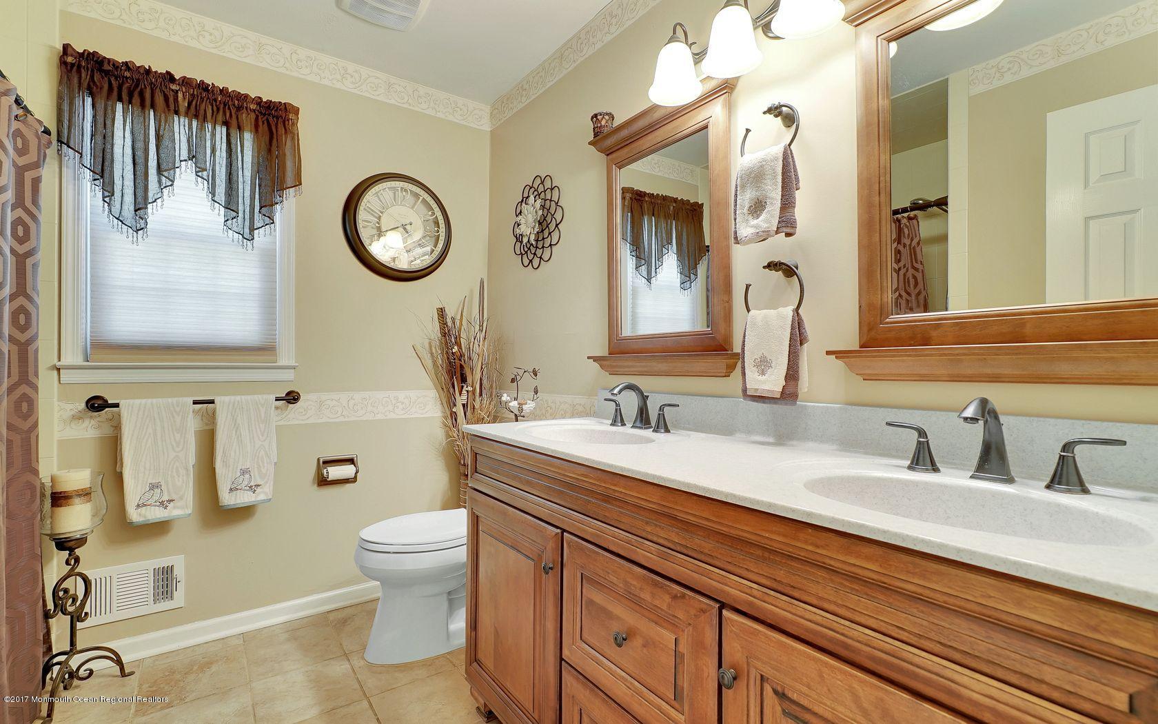9 Cornwall Road Freehold, NJ 07728 - Photo 28 of 38 a bathroom with a toilet a sink and a mirror