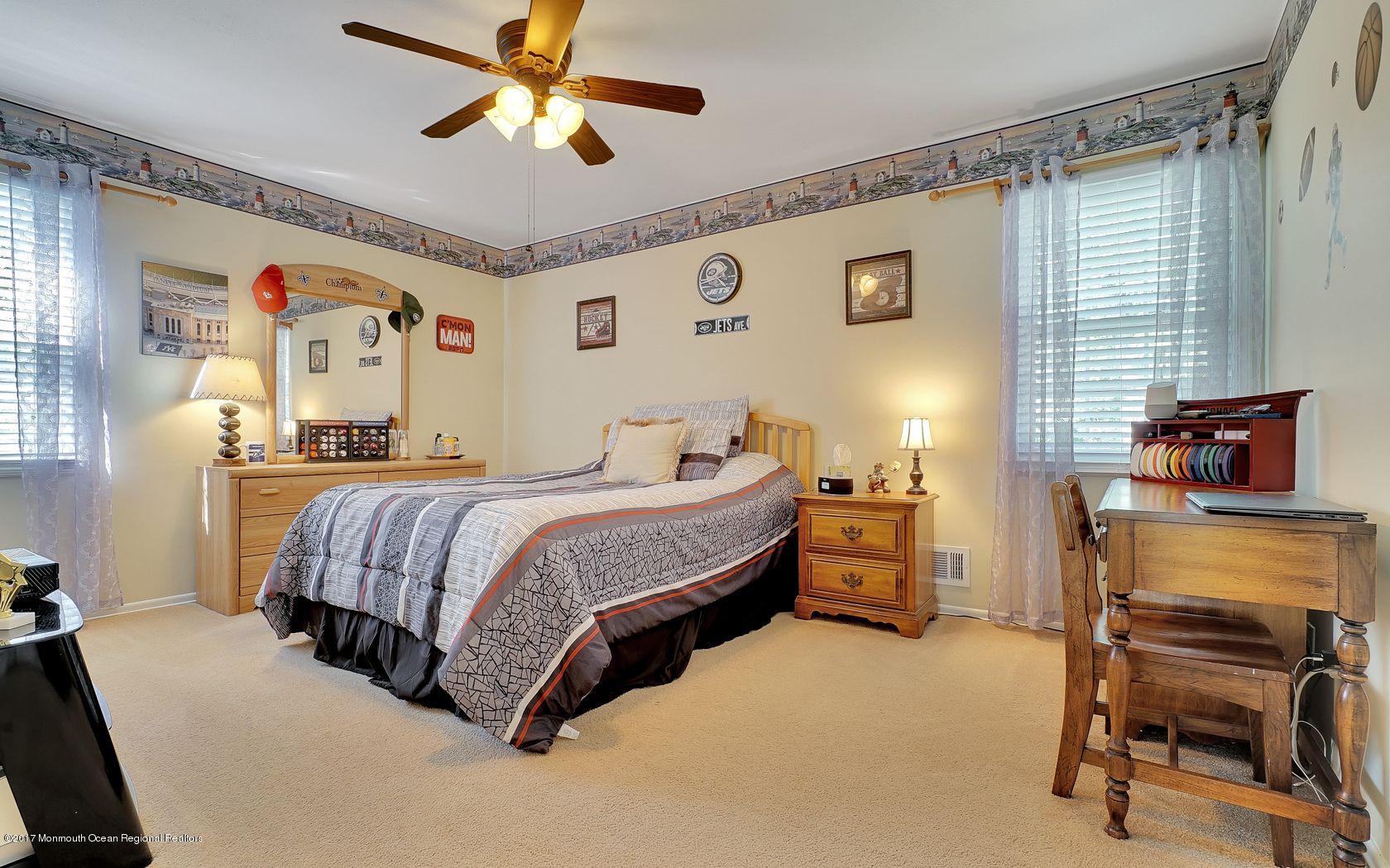 9 Cornwall Road Freehold, NJ 07728 - Photo 29 of 38 a bedroom with a bed and a chandelier