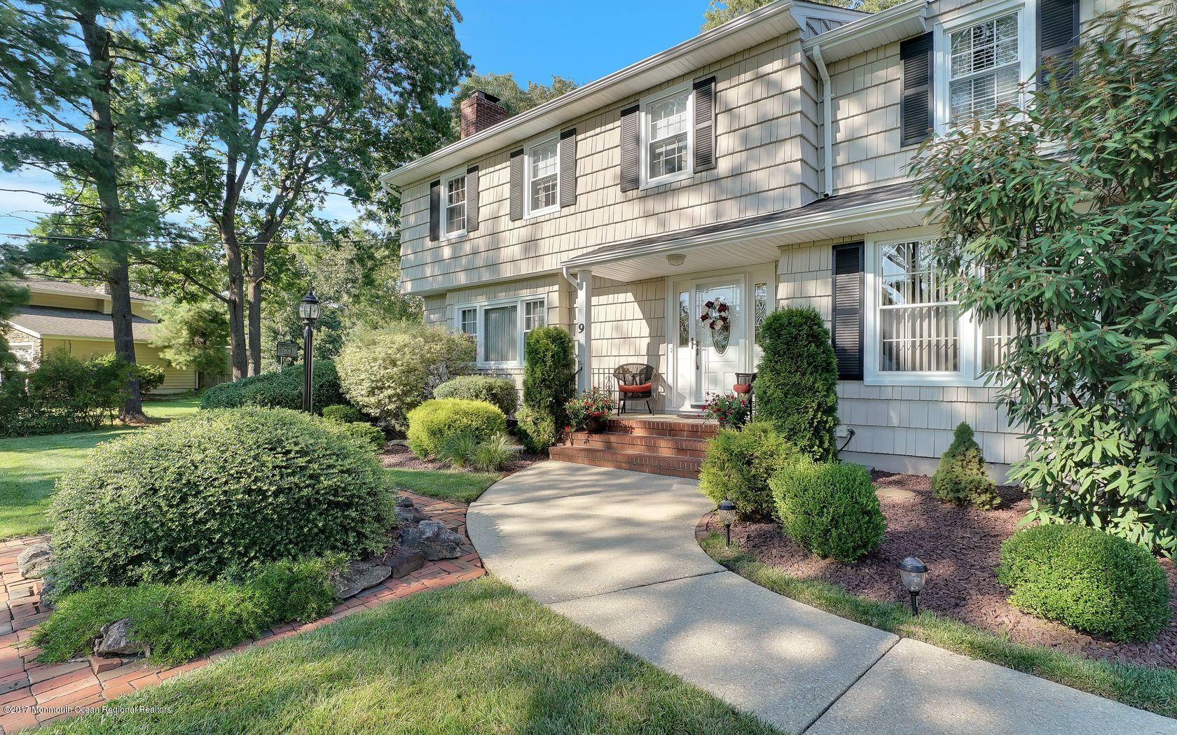 9 Cornwall Road Freehold, NJ 07728 - Photo 3 of 38 a view of a building with potted plants and a fountain