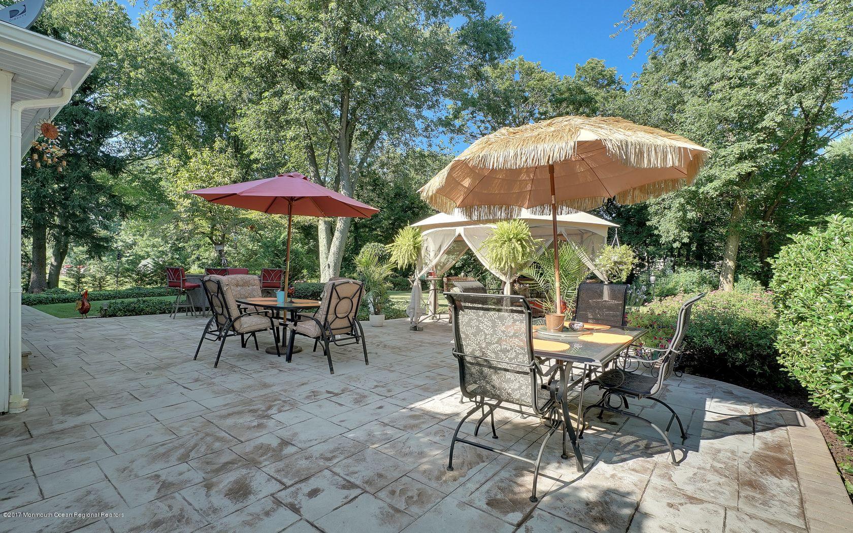 9 Cornwall Road Freehold, NJ 07728 - Photo 34 of 38 a view of a table and chairs under an umbrella