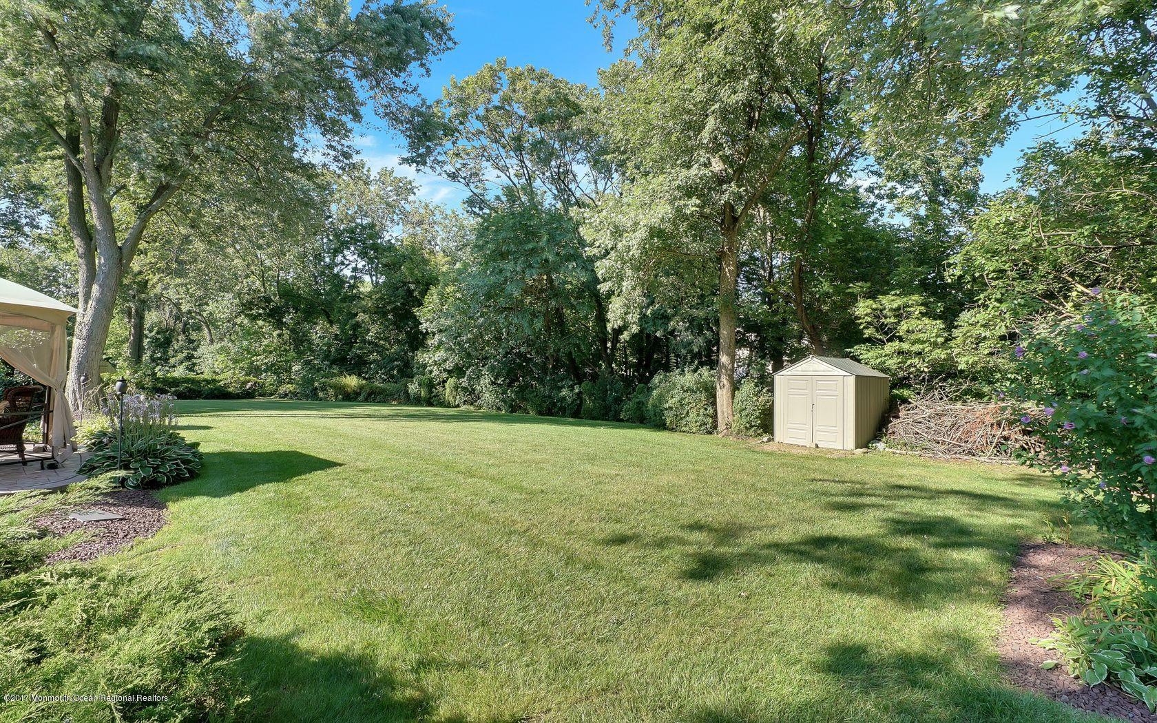 9 Cornwall Road Freehold, NJ 07728 - Photo 38 of 38 a view of a garden with large trees
