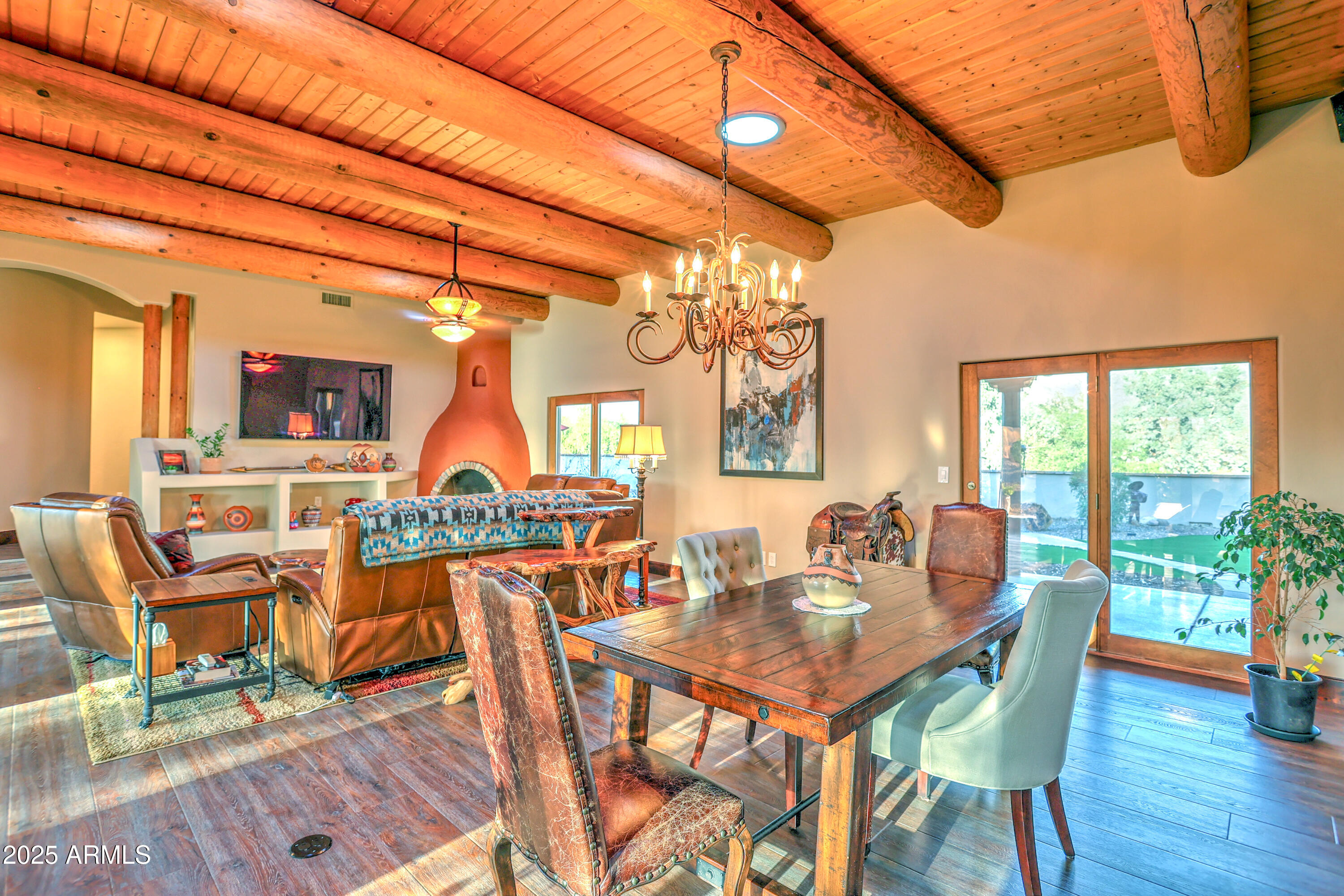11484 North 1st Avenue Tucson, AZ 85737 - Photo 18 of 47 a dining room with furniture a chandelier and wooden floor
