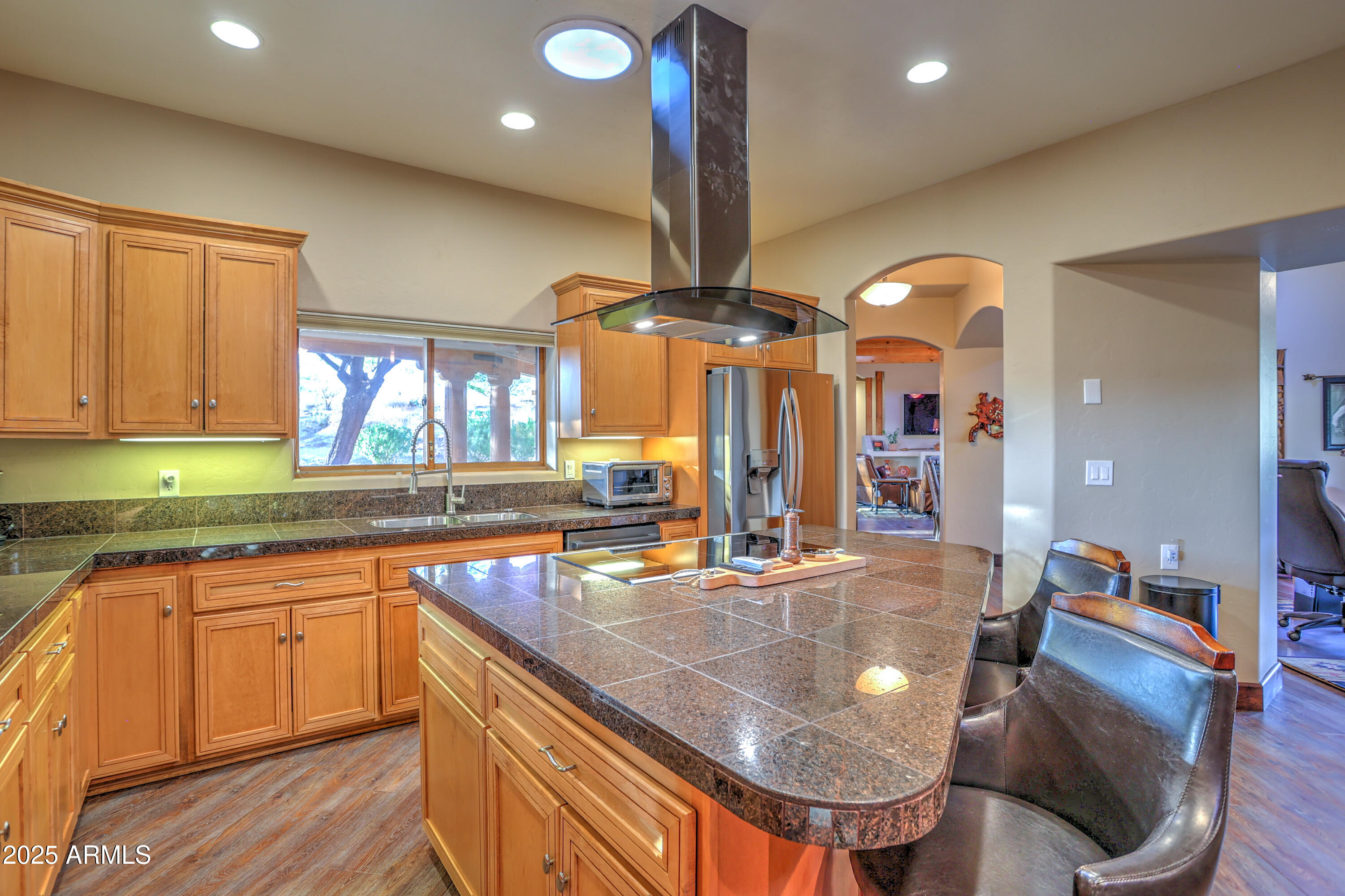 11484 North 1st Avenue Tucson, AZ 85737 - Photo 21 of 47 a kitchen with stainless steel appliances granite countertop a sink dishwasher and cabinets with wooden floor