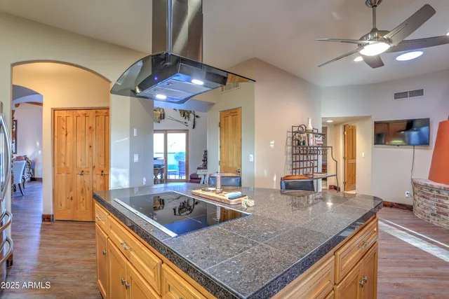 a kitchen with stainless steel appliances granite countertop a sink dishwasher and cabinets with wooden floor