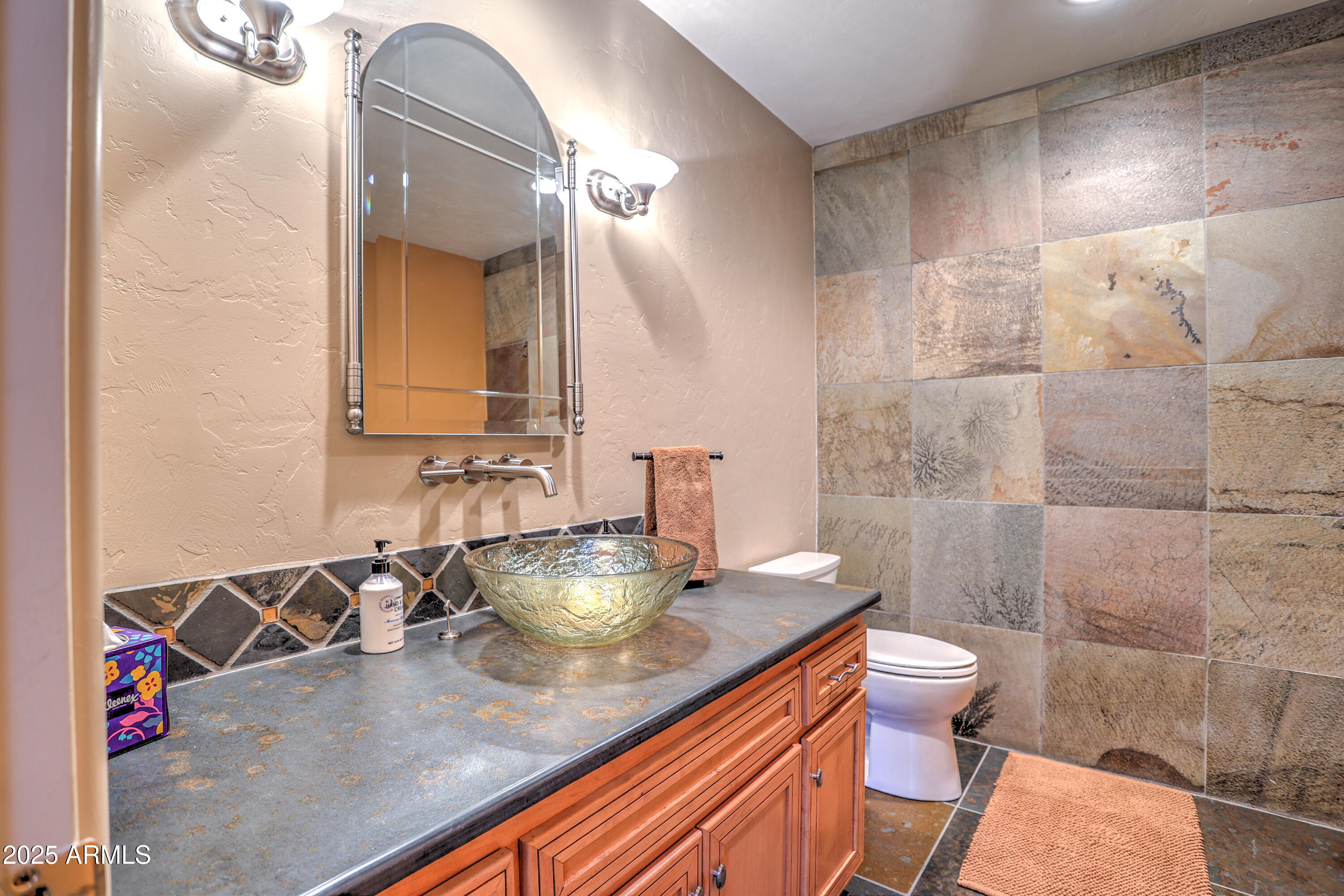 11484 North 1st Avenue Tucson, AZ 85737 - Photo 26 of 47 a bathroom with a granite countertop sink a toilet and a mirror