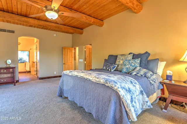 a bathroom with a granite countertop sink a toilet and a mirror
