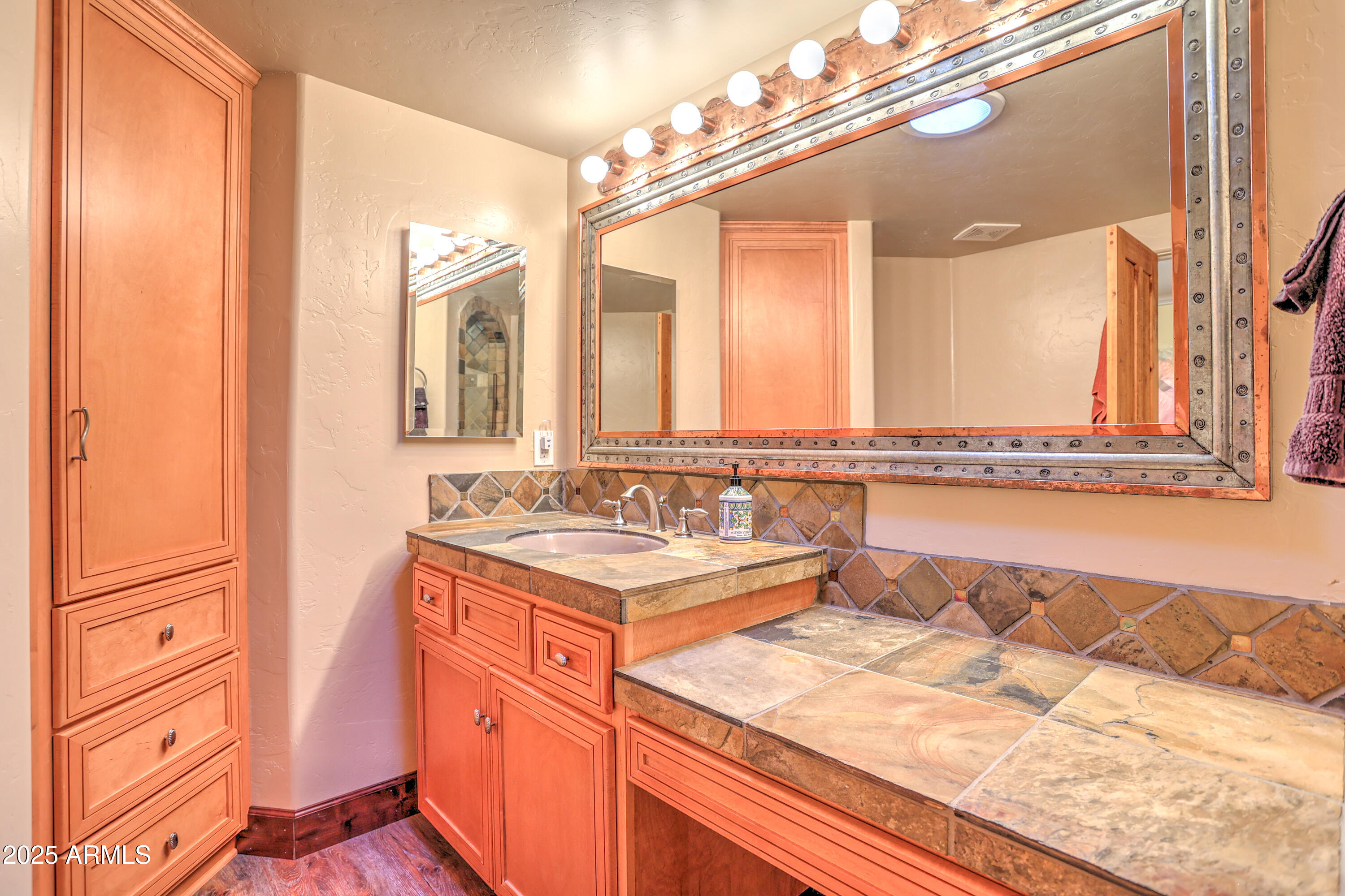 11484 North 1st Avenue Tucson, AZ 85737 - Photo 32 of 47 a bathroom with a sink and a mirror