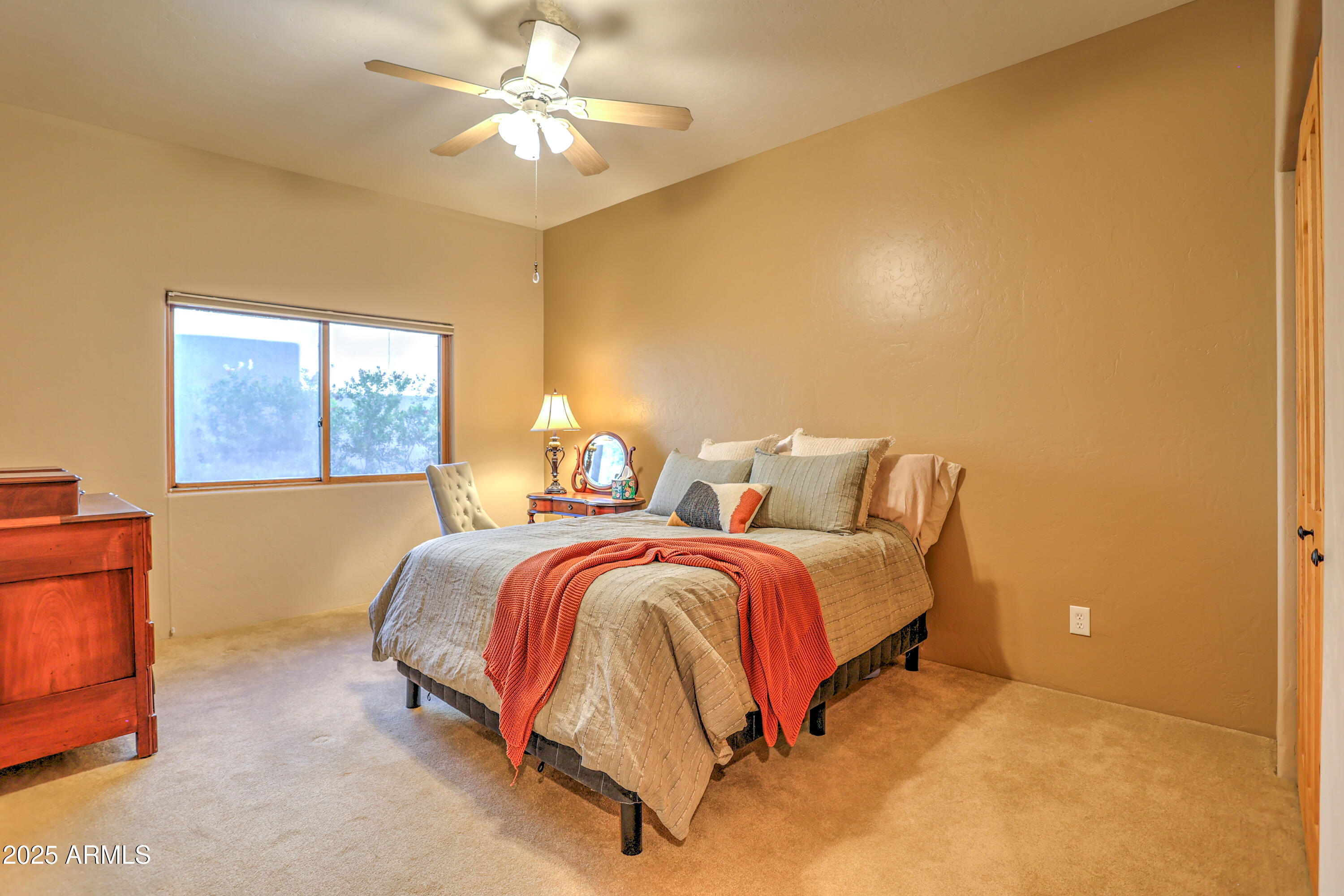 11484 North 1st Avenue Tucson, AZ 85737 - Photo 34 of 47 a spacious bedroom with a bed and a chandelier