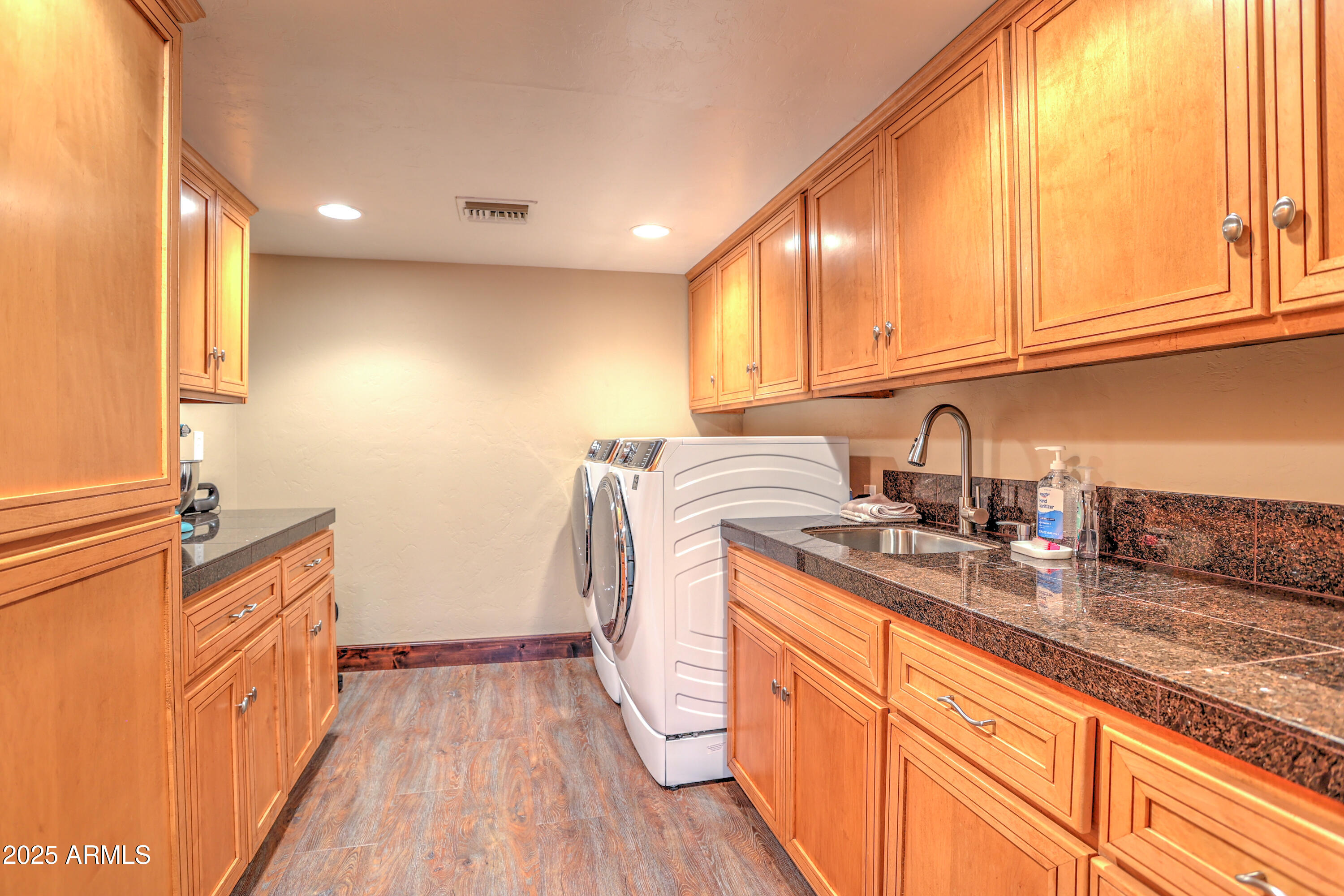 11484 North 1st Avenue Tucson, AZ 85737 - Photo 36 of 47 a kitchen with sink a refrigerator and wooden cabinets