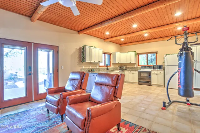 a kitchen with sink a refrigerator and wooden cabinets
